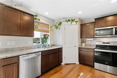 Kitchen with stainless steel appliances, a sink, l