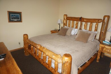 Bedroom with baseboards and carpet floors