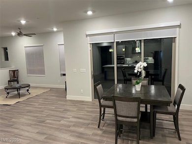 Dining space featuring baseboards, a ceiling fan,