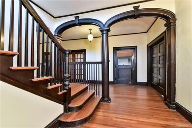 Hardwood details throughout the home including floors, archways, banisters, moldings, and more!