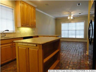 The open kitchen has slab granite counter tops (by