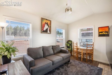 Living area featuring wood finished floors, basebo