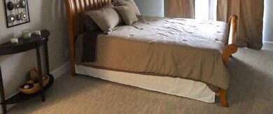Very spacious main bedroom.  Now has wood laminate
