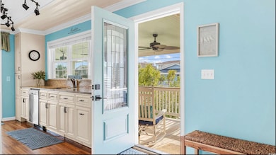 Doorway to outside featuring crown molding, dark wood finished floors, and ceiling fan