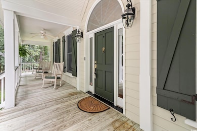 Wooden terrace featuring ceiling fan