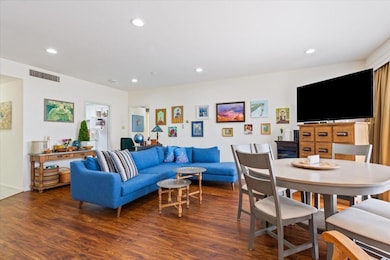 Living area featuring recessed lighting and wood f