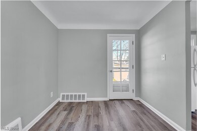 Doorway featuring plenty of natural light and light wood-type flooring