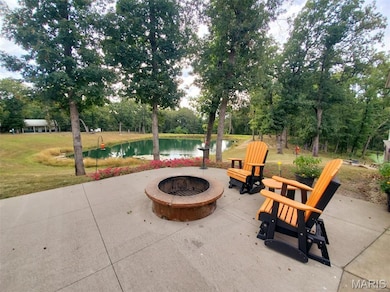 View of patio featuring a fire pit and a water view