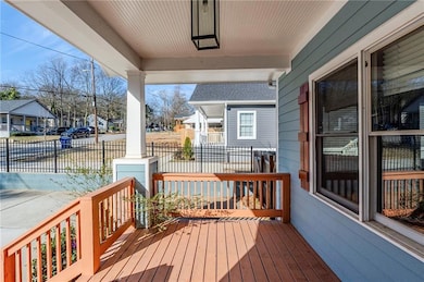 Deck featuring covered porch and a residential vie