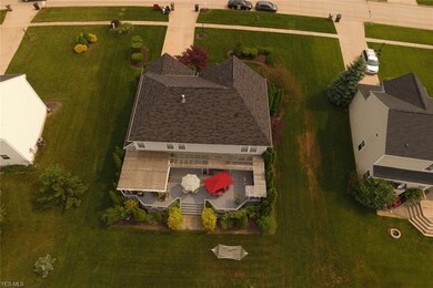 Bak view of the home shows a partially covered dec