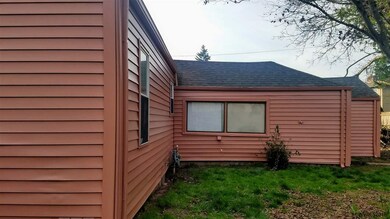 Straight shot of NE side of house and back yard.