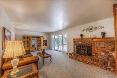 Living room features a beautiful brick fireplace a
