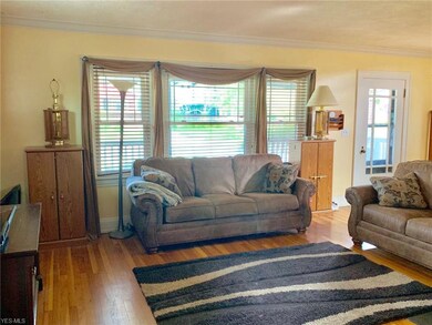 Living Room area with lots of lighting and hardwood floors