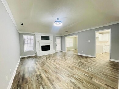 Unfurnished living room with crown molding, wood-t
