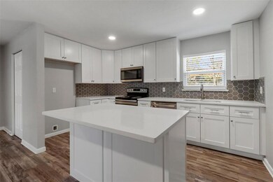Remodeled kitchen complete with quartz countertops