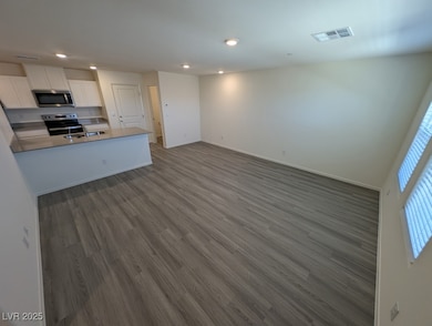 Kitchen featuring stainless steel microwave, range