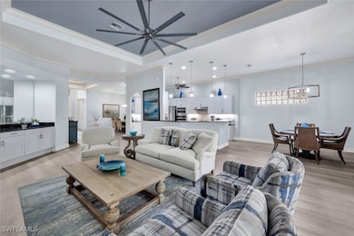 Living room featuring ceiling fan with notable cha