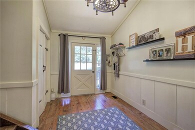 Entryway featuring visible vents, a wainscoted wal