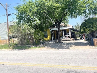 View of front of house featuring a porch and a ca