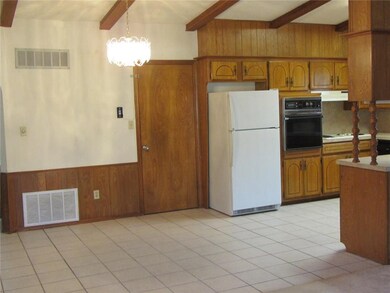 Vaulted ceiling continues in kitchen & dining area