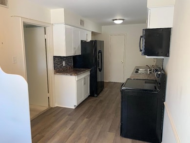 Kitchen featuring backsplash, range with electric 