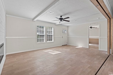 Unfurnished living room with a textured ceiling, v