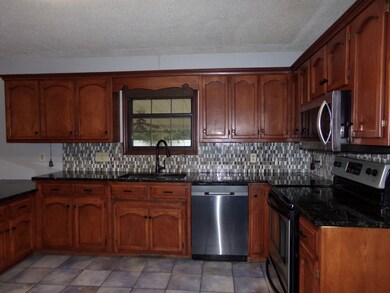 Tile backsplash and a window looking out over the back yard