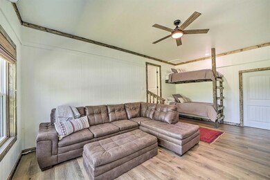 Living area with a ceiling fan and wood finished f