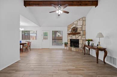 Living room featuring beam ceiling, a ceiling fan
