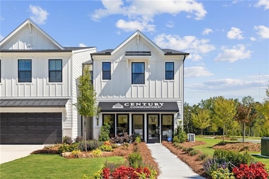 View of property with an attached garage and driveway