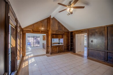 Living area features vaulted ceilings and large wi