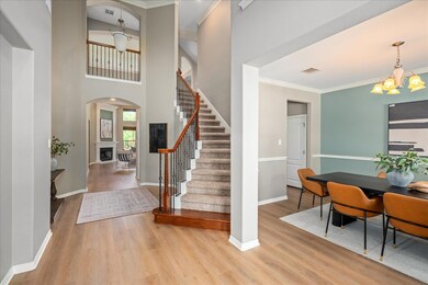 Foyer entrance featuring a chandelier, wood finis