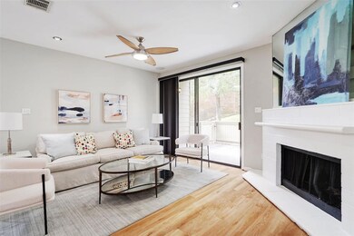 Living area featuring wood finished floors, a cei