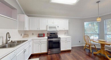 Eat in Kitchen has dark stainless electric range, 