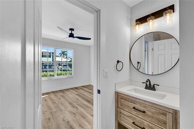 Bathroom featuring baseboards, vanity, ceiling fan
