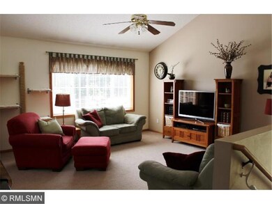 Spacious living room with vaulted ceiling and fan 