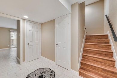Stairs featuring baseboards, tile patterned floori