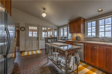 Light and bright eat-in kitchen has a vaulted ceil