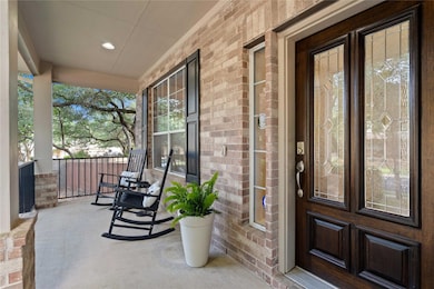 Entrance to property with a porch, brick siding, 