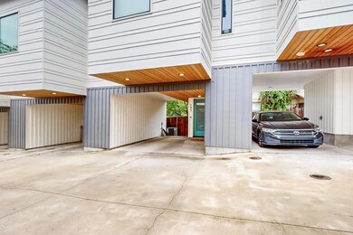 Garage with a carport and driveway