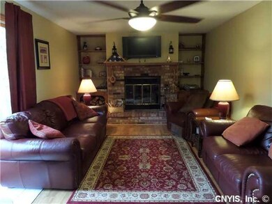 Family Room Cozy and warm fireplace with brick surround, built in cases and slider to back decks