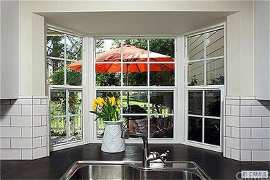 Kitchen view to cottage garden setting patio
