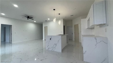 Kitchen featuring recessed lighting, light marble