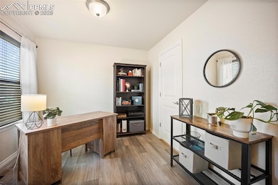 Office with wood finished floors and baseboards