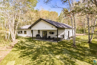 Rear view of house featuring a lawn, an outdoor hangout area, and a patio area