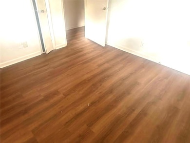Spare room featuring dark hardwood / wood-style floors