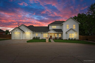 View of front facade featuring concrete driveway,