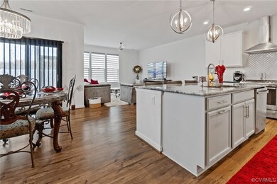 Kitchen with dark wood-type flooring, wall chimney