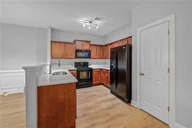 Kitchen featuring light countertops, a sink, light