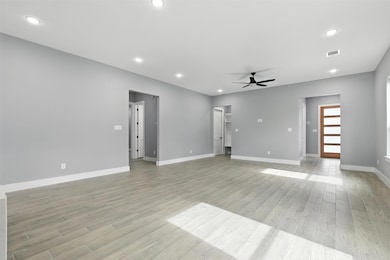 This spacious living area features modern gray wal